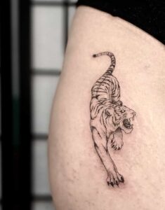 semi realism hip fine line tiger tattoo